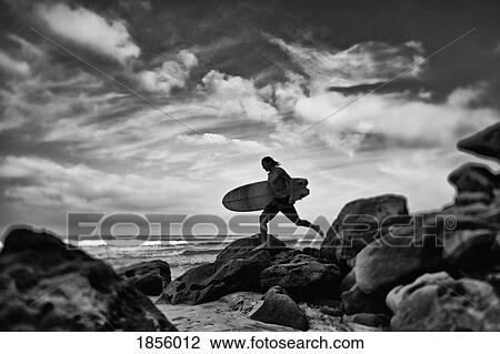 Male surfer with surfboard on rocky ocean beach, Higuera Blanca, Nayarit, Mexico View Large Photo Image Stock Image - Male surfer with surfboard on rocky ocean beach, Higuera Blanca, Nayarit, Mexico. Fotosearch