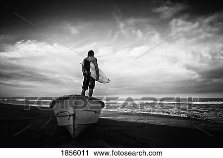 Male surfer with surfboard standing on beached boat, Higuera Blanca, Nayarit, Mexico View Large Photo Image Stock Image - Male surfer with surfboard standing on beached boat, Higuera Blanca, Nayarit, Mexico. Fotosearch