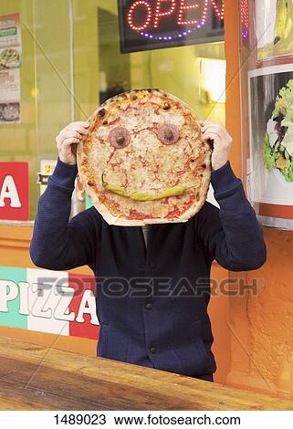 Man holding pizza with anthropomorphic face View Large Photo Image Stock Image - Man holding pizza with anthropomorphic face. Fotosearch