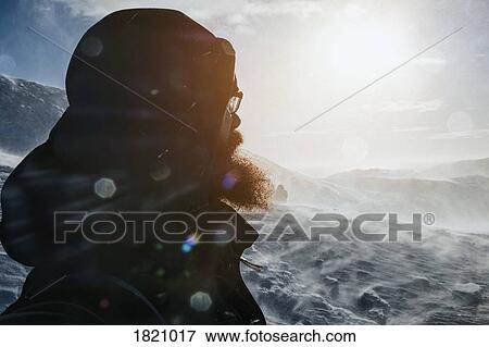 Man looking at snowy landscape, Reykjadalur, Iceland View Large Photo Image Stock Photo - Man looking at snowy landscape, Reykjadalur, Iceland. Fotosearch
