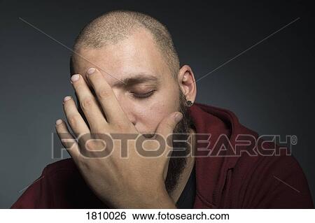 Man with eyes closed covering face with hands View Large Photo Image Stock Photograph - Man with eyes closed covering face with hands. Fotosearch
