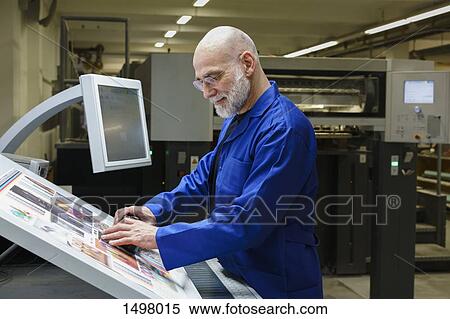 Mature man doing quality check of printout with scanner at printing press View Large Photo Image Stock Photography - Mature man doing quality check of printout with scanner at printing press. Fotosearch