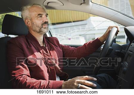 Mature man driving car on sunny day View Large Photo Image Stock Image - Mature man driving car on sunny day. Fotosearch