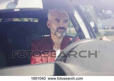 Mature man driving car seen through windshield View Large Photo Image Stock Image - Mature man driving car seen through windshield. Fotosearch
