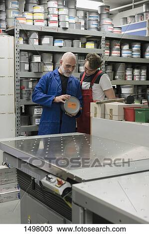 Mature man talking with coworker in printing workshop View Large Photo Image Stock Image - Mature man talking with coworker in printing workshop. Fotosearch
