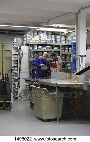 Mature man talking with coworker in printing workshop View Large Photo Image Stock Image - Mature man talking with coworker in printing workshop. Fotosearch