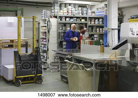 Mature man talking with coworker in printing workshop View Large Photo Image Stock Photo - Mature man talking with coworker in printing workshop. Fotosearch