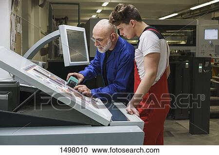 Mature worker showing colleague quality of printout with scanner at printing press View Large Photo Image Stock Image - Mature worker showing colleague quality of printout with scanner at printing press. Fotosearch