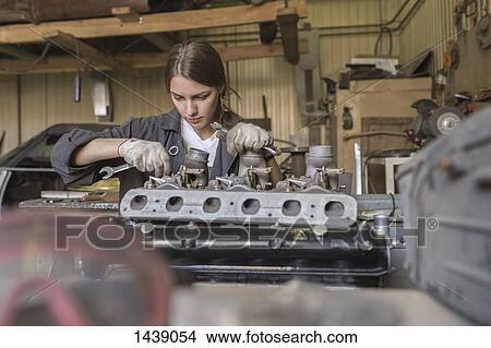 Mechanic repairing car engine at garage View Large Photo Image Picture - Mechanic repairing car engine at garage. Fotosearch