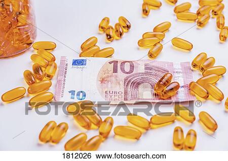 Stock Photograph - Medicine capsules and ten Euro banknote. Fotosearch
