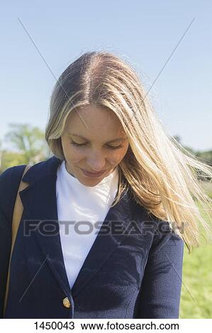 Mid adult businesswoman looking down View Large Photo Image Stock Image - Mid adult businesswoman looking down. Fotosearch