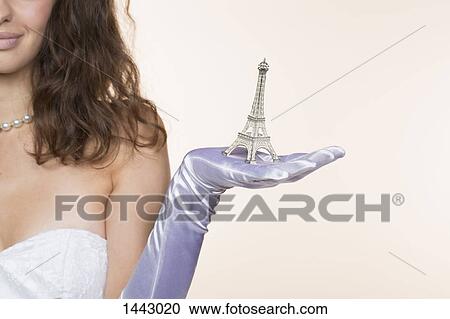 Midsection of bride holding Eiffel Tower model against white background View Large Photo Image Stock Image - Midsection of bride holding Eiffel Tower model against white background. Fotosearch