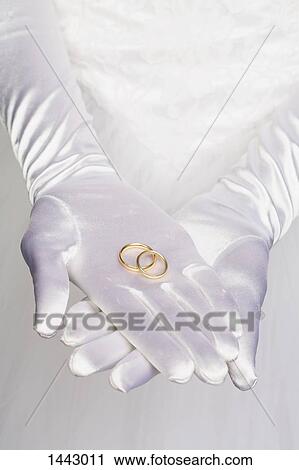 Midsection of bride holding wedding rings View Large Photo Image Stock Image - Midsection of bride holding wedding rings. Fotosearch