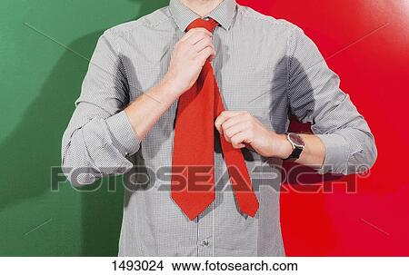 Picture - Midsection of businessman with sweaty armpits wearing necktie against colored background. Fotosearch