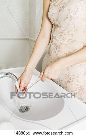 Midsection of woman washing toothbrush at bathroom sink View Large Photo Image Stock Photography - Midsection of woman washing toothbrush at bathroom sink. Fotosearch