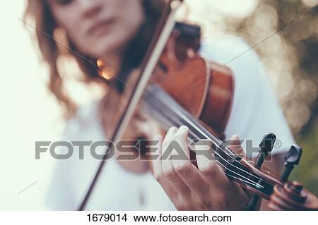 Midsection of young woman playing violin View Large Photo Image Picture - Midsection of young woman playing violin. Fotosearch