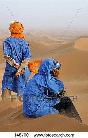 Moroccan men dressed in traditional clothing relaxing at Erg Chebbi desert, Morocco View Large Photo Image Stock Image - Moroccan men dressed in traditional clothing relaxing at Erg Chebbi desert, Morocco. Fotosearch