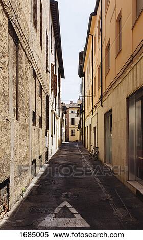 Narrow alley amidst residential buildings in city, Faenza, Italy View Large Photo Image Stock Photography - Narrow alley amidst residential buildings in city, Faenza, Italy. Fotosearch