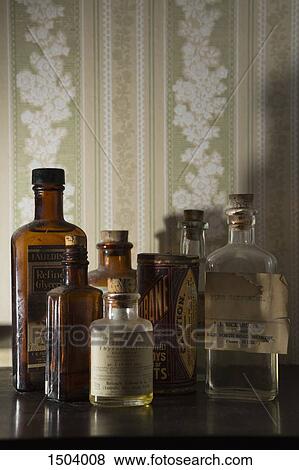 Old-fashioned glass bottles on a wooden table View Large Photo Image Stock Photo - Old-fashioned glass bottles on a wooden table. Fotosearch
