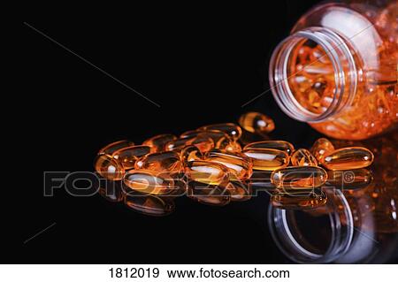 Orange medicine capsules on black background View Large Photo Image Stock Photo - Orange medicine capsules on black background. Fotosearch