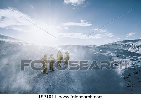 People walking along sunny, windy, snow covered landscape, Reykjadalur, Iceland View Large Photo Image Stock Image - People walking along sunny, windy, snow covered landscape, Reykjadalur, Iceland. Fotosearch