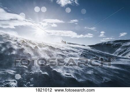People walking along sunny, windy, snow covered mountain, Reykjadalur, Iceland View Large Photo Image Stock Image - People walking along sunny, windy, snow covered mountain, Reykjadalur, Iceland. Fotosearch