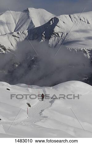 Person skiing on snow covered mountain View Large Photo Image Stock Image - Person skiing on snow covered mountain. Fotosearch