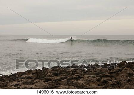 Person surfing at beach, Vila Nova de Milfontes, Portugal View Large Photo Image Stock Photograph - Person surfing at beach, Vila Nova de Milfontes, Portugal. Fotosearch