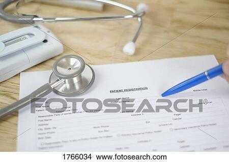 Personal perspective patient filling out medical patient registration form View Large Photo Image Picture - Personal perspective patient filling out medical patient registration form. Fotosearch