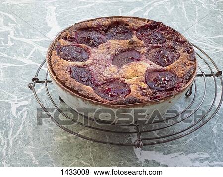 Stock Photo - Pie on bowl on metal grate. Fotosearch