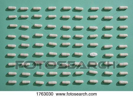 Pill standing out from crowd of capsules on green background View Large Photo Image Stock Image - Pill standing out from crowd of capsules on green background. Fotosearch