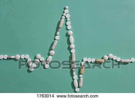 Pills forming pulse trace on green background View Large Photo Image Picture - Pills forming pulse trace on green background. Fotosearch