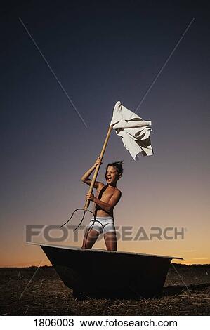 Playful boy in underwear waving pitchfork white flag in bathtub in rural field View Large Photo Image Stock Image - Playful boy in underwear waving pitchfork white flag in bathtub in rural field. Fotosearch