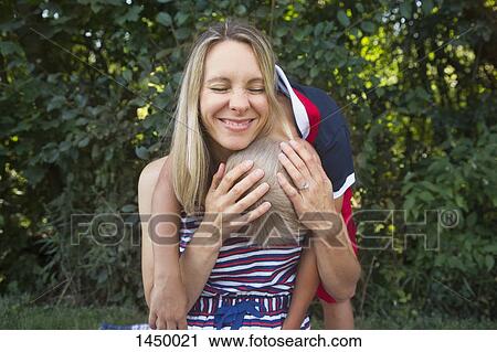 Playful mother and son in backyard View Large Photo Image Stock Image - Playful mother and son in backyard. Fotosearch