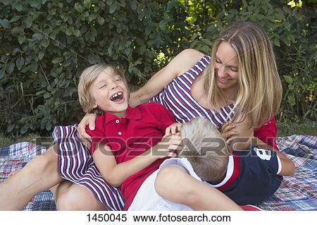 Playful mother and sons in backyard View Large Photo Image Stock Photography - Playful mother and sons in backyard. Fotosearch