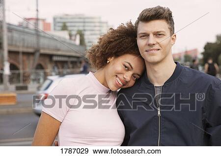 Portrait affectionate young couple on urban sidewalk View Large Photo Image Stock Photo - Portrait affectionate young couple on urban sidewalk. Fotosearch