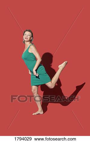 Portrait confident, barefoot woman on red background View Large Photo Image Stock Photo - Portrait confident, barefoot woman on red background. Fotosearch