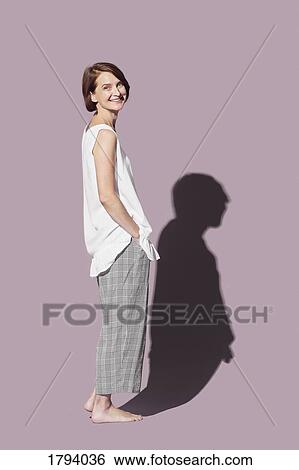 Portrait confident, barefoot woman on pink background View Large Photo Image Stock Photograph - Portrait confident, barefoot woman on pink background. Fotosearch