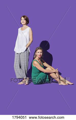 Portrait confident, barefoot women against purple background View Large Photo Image Stock Image - Portrait confident, barefoot women against purple background. Fotosearch