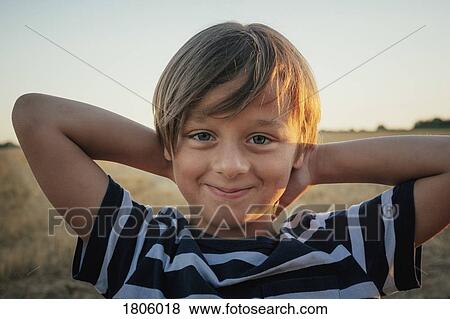 Portrait confident boy with hands behind head View Large Photo Image Stock Photo - Portrait confident boy with hands behind head. Fotosearch