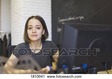 Portrait confident businesswoman working at computer in office View Large Photo Image Stock Image - Portrait confident businesswoman working at computer in office. Fotosearch