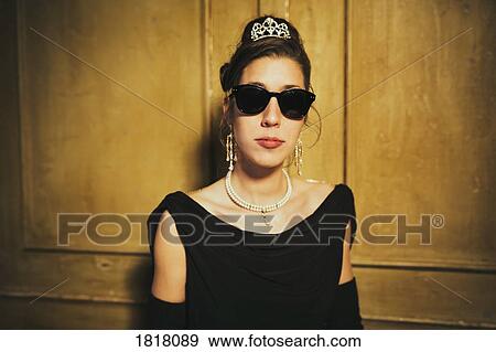 Portrait confident, cool elegant woman wearing sunglasses and tiara View Large Photo Image Stock Photo - Portrait confident, cool elegant woman wearing sunglasses and tiara. Fotosearch