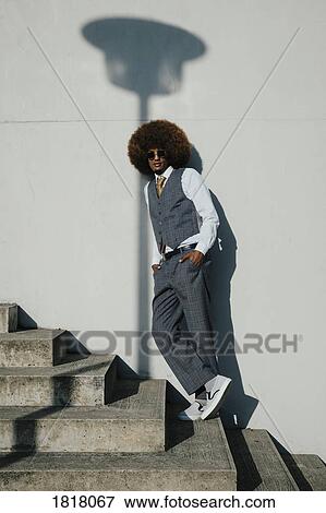 Portrait confident, cool, well-dressed young man with afro on urban steps View Large Photo Image Stock Photo - Portrait confident, cool, well-dressed young man with afro on urban steps. Fotosearch