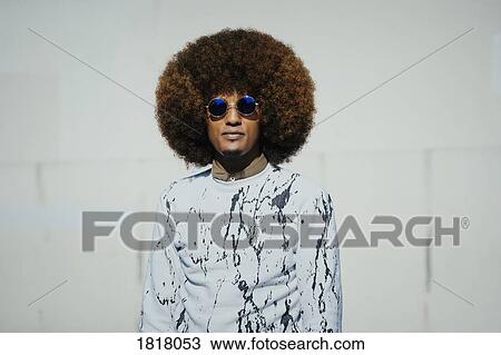 Stock Image - Portrait confident, cool young man with afro. Fotosearch