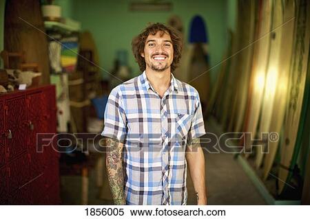 Portrait confident, happy male surf shop owner View Large Photo Image Stock Photography - Portrait confident, happy male surf shop owner. Fotosearch