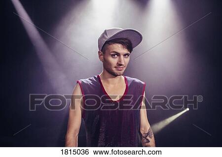 Stock Photograph - Portrait confident male dancer on stage. Fotosearch