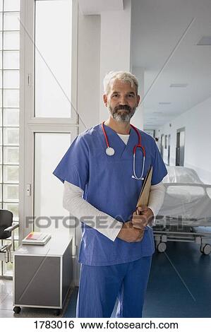 Stock Photograph - Portrait confident male doctor in hospital corridor. Fotosearch