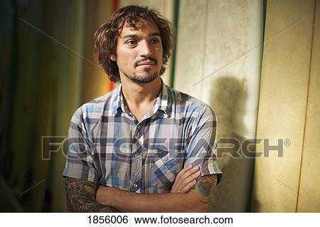 Portrait confident male surf shop owner with arms crossed View Large Photo Image Stock Photograph - Portrait confident male surf shop owner with arms crossed. Fotosearch
