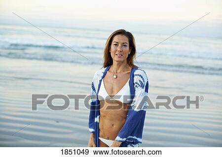 Portrait confident woman in bikini on ocean beach View Large Photo Image Stock Photo - Portrait confident woman in bikini on ocean beach. Fotosearch