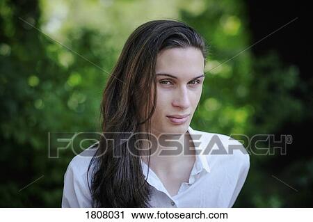 Portrait confident young man with long hair View Large Photo Image Stock Image - Portrait confident young man with long hair. Fotosearch
